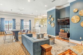 a living room with a couch and a ping pong table